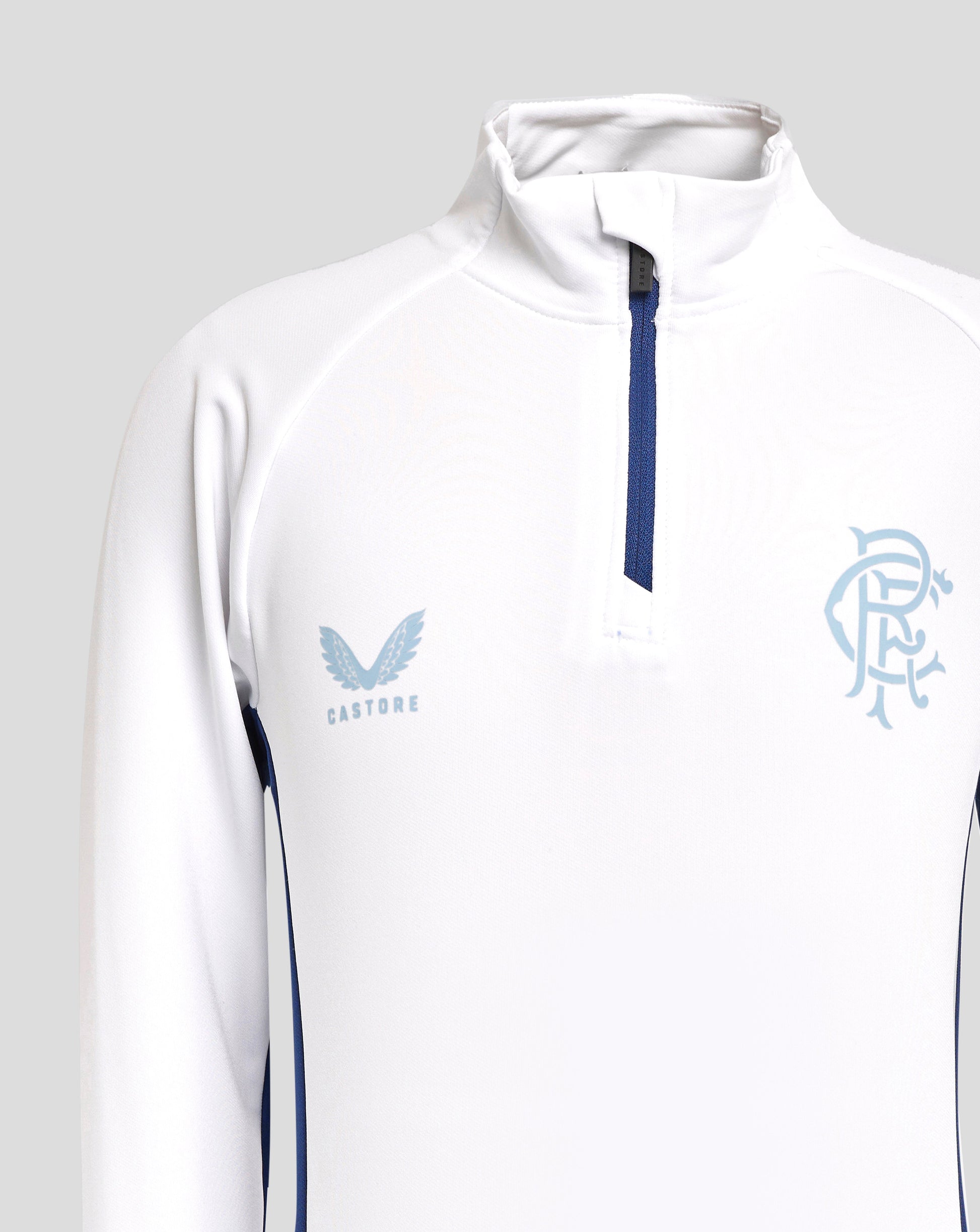 Close up of white quarter zip top showing collar blue zipper and crest on chest