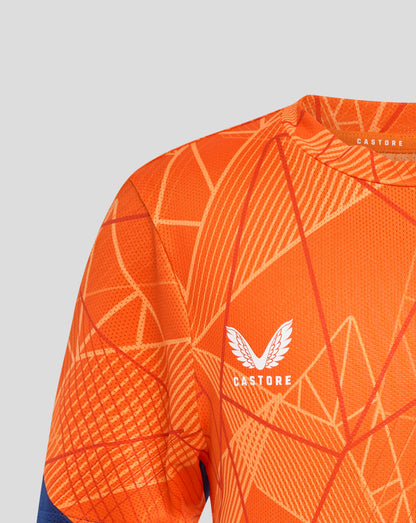 Close up of orange Rangers 24/25 Junior League Matchday T Shirt fabric with white geometric lines and Castore label at the collar.
