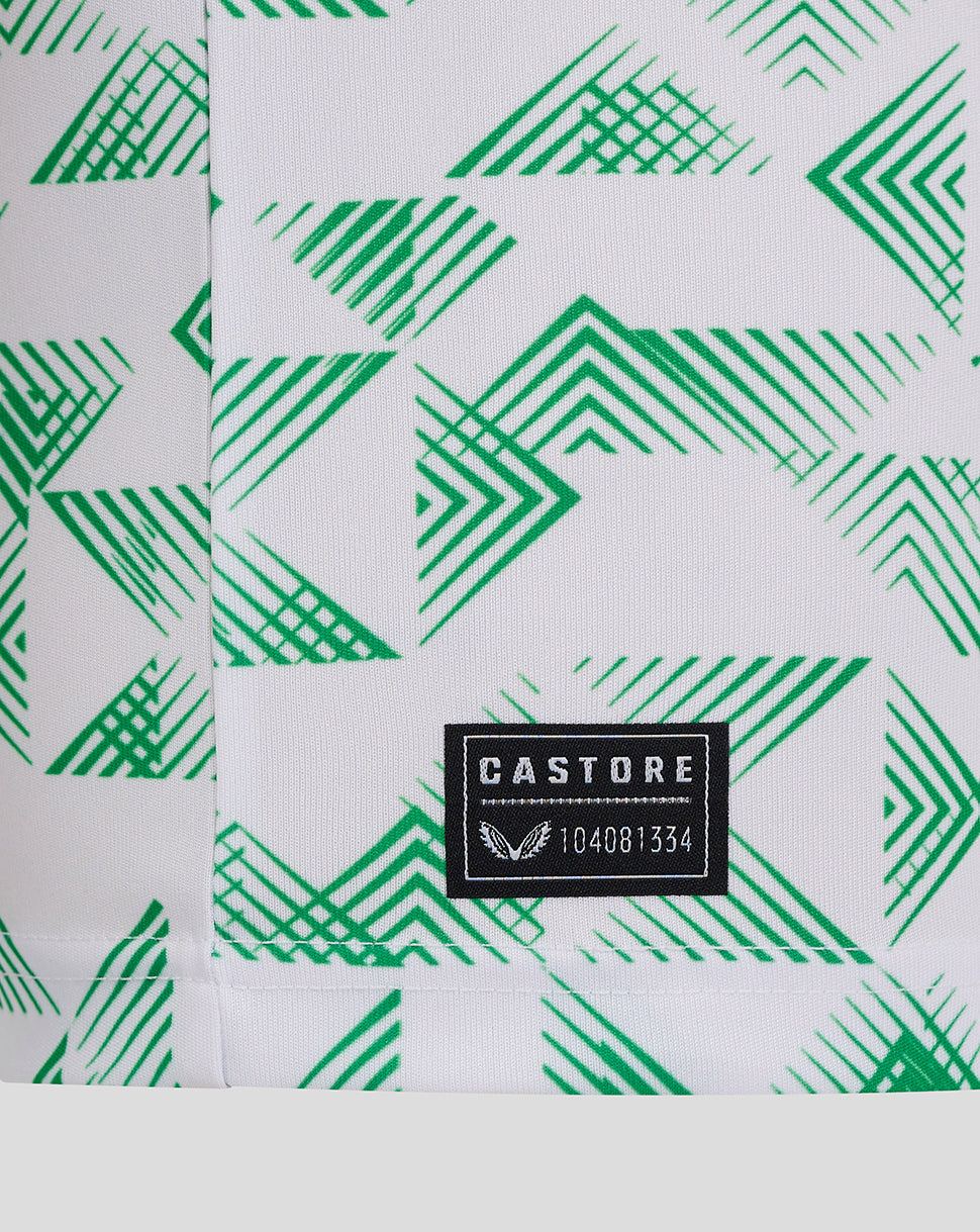 Close-up of green geometric pattern on Mansfield Junior Away Shirt with Castore label at hem.