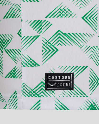 Close-up of green geometric pattern on Mansfield Junior Away Shirt with Castore label at hem.