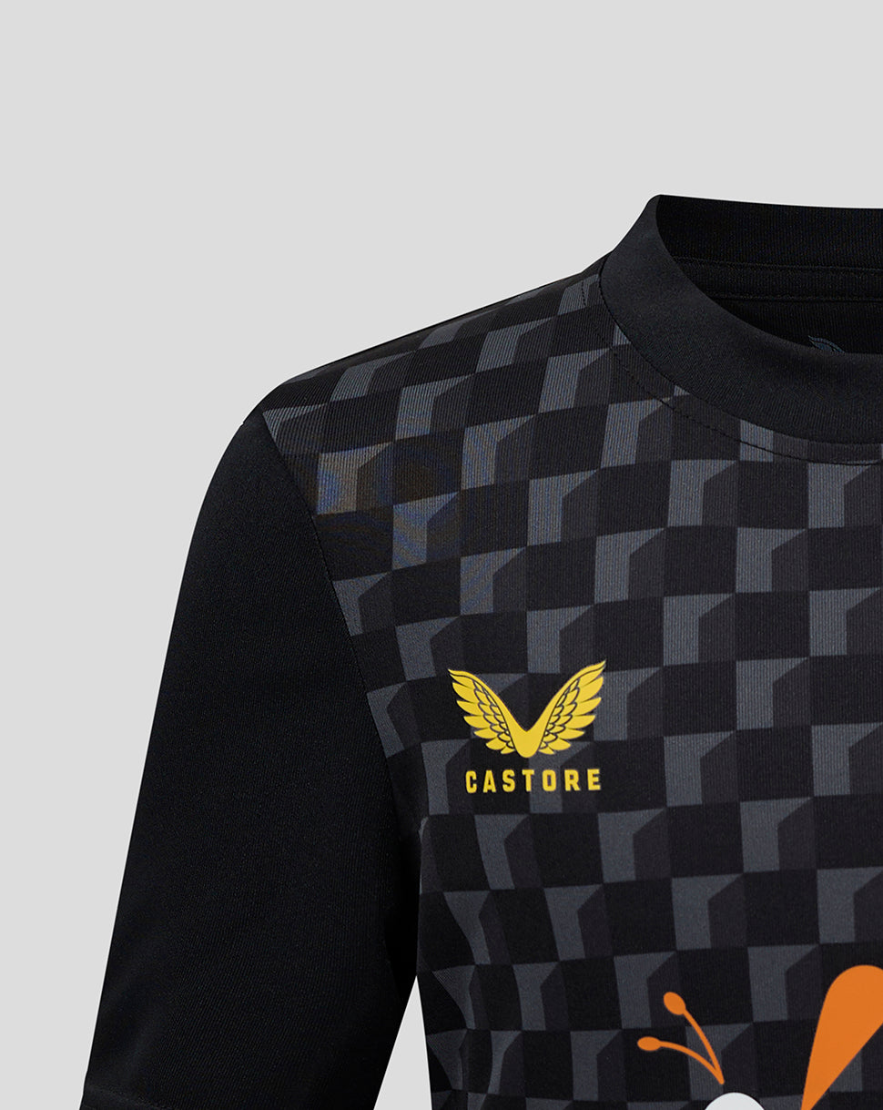 Front view of Mansfield Junior shirt with black checkerboard pattern and yellow Castore crest on left chest