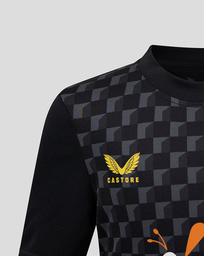 Front view of Mansfield Junior shirt with black checkerboard pattern and yellow Castore crest on left chest