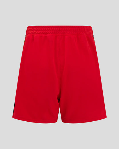 Red Mk Dons junior away shorts with a black and gold side stripe