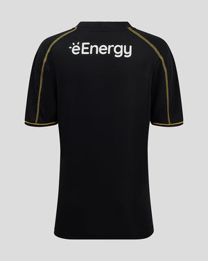 Back view of black MK DONS junior 24/25 third shirt with white éEnergy logo and gold shoulder piping.