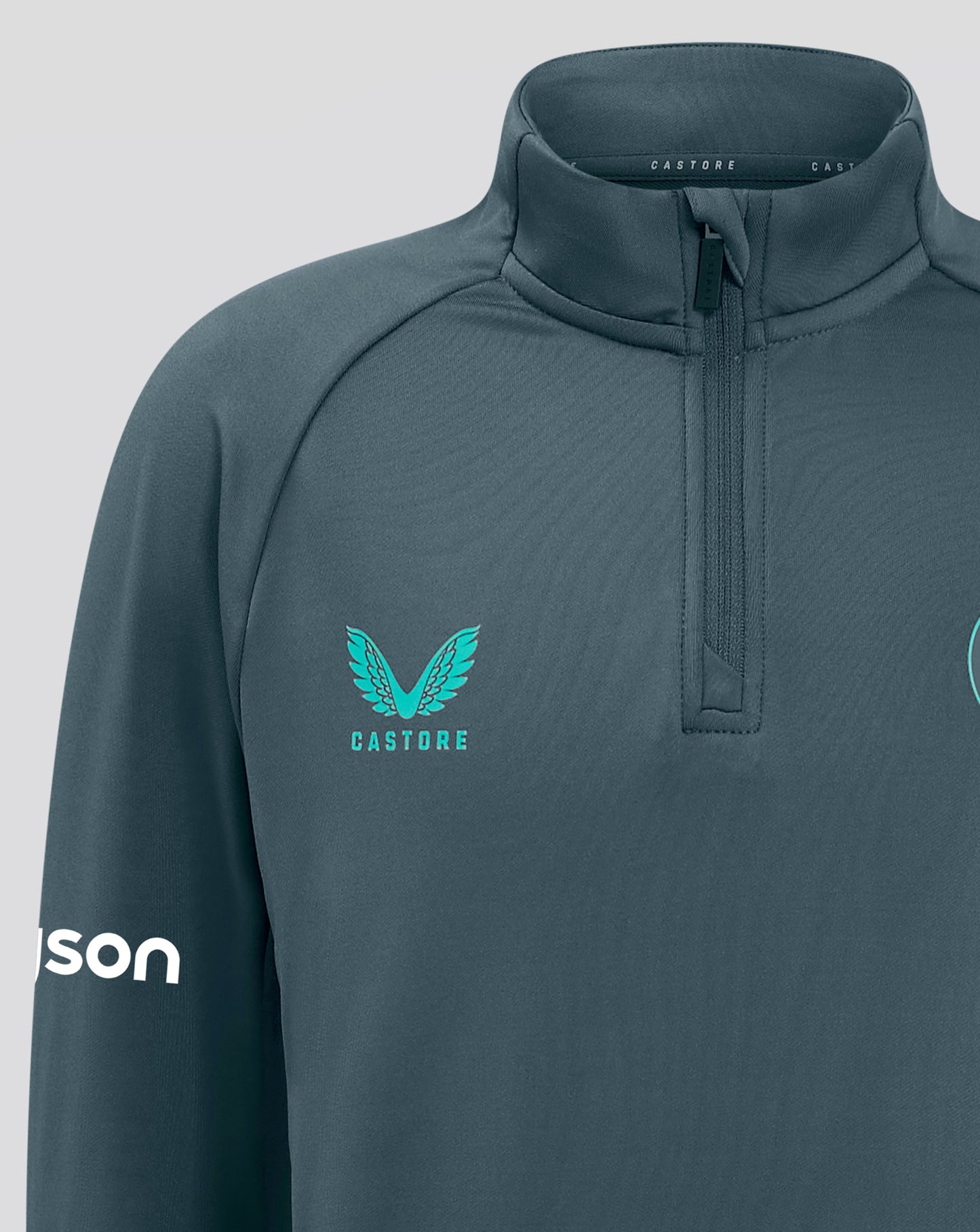 Front close up of Bath Rugby Junior training top showing the quarter zip and teal chest crest.