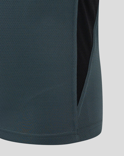 Close up of teal Bath Rugby junior training shirt fabric with a dotted perforated pattern and a side panel seam
