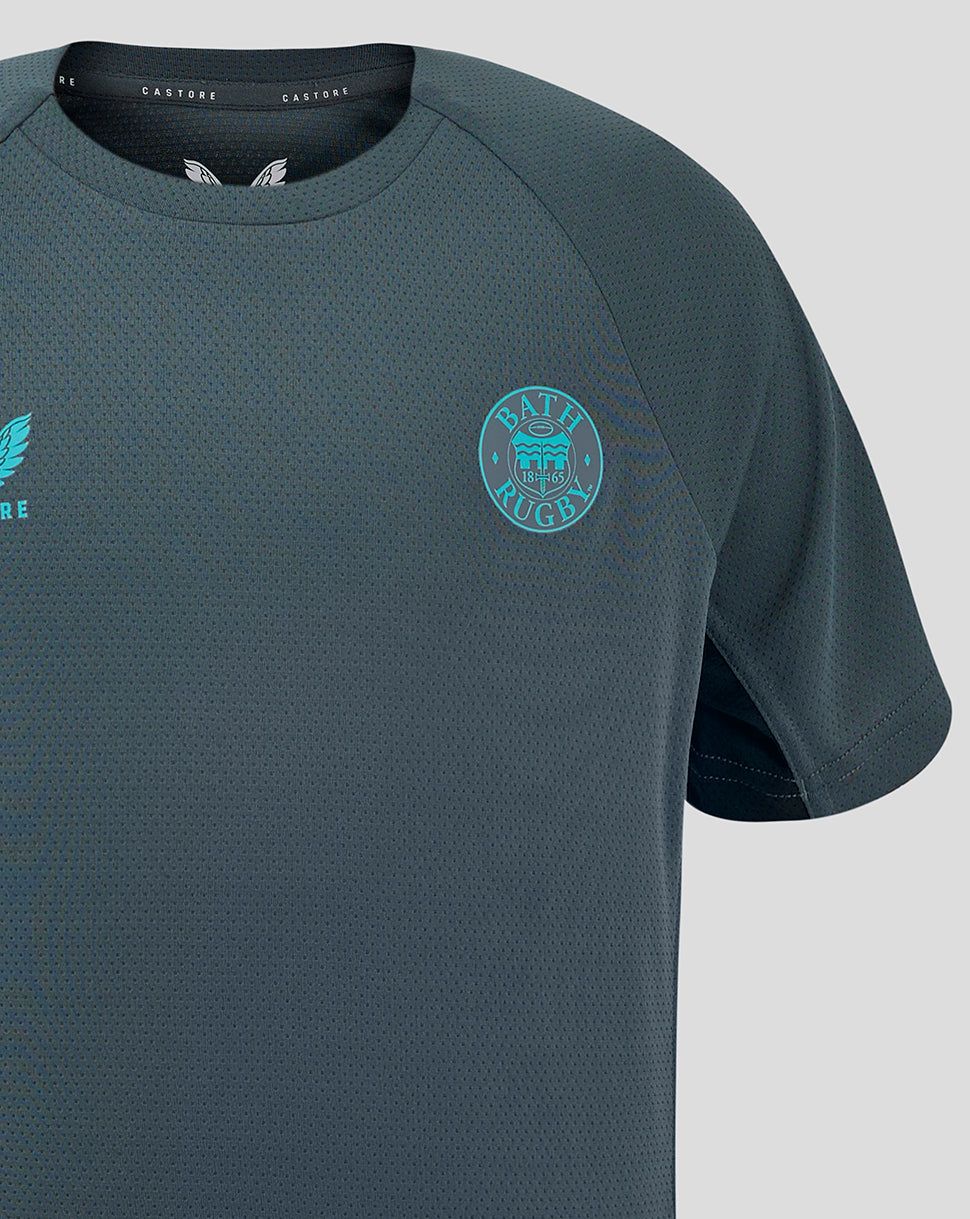 Front close-up of Bath Rugby Junior training T shirt showing turquoise left chest crest and Castore branding on right chest