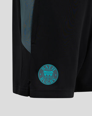 Close up of Bath Rugby Junior shorts in black with teal side panel and Bath Rugby crest on the right thigh