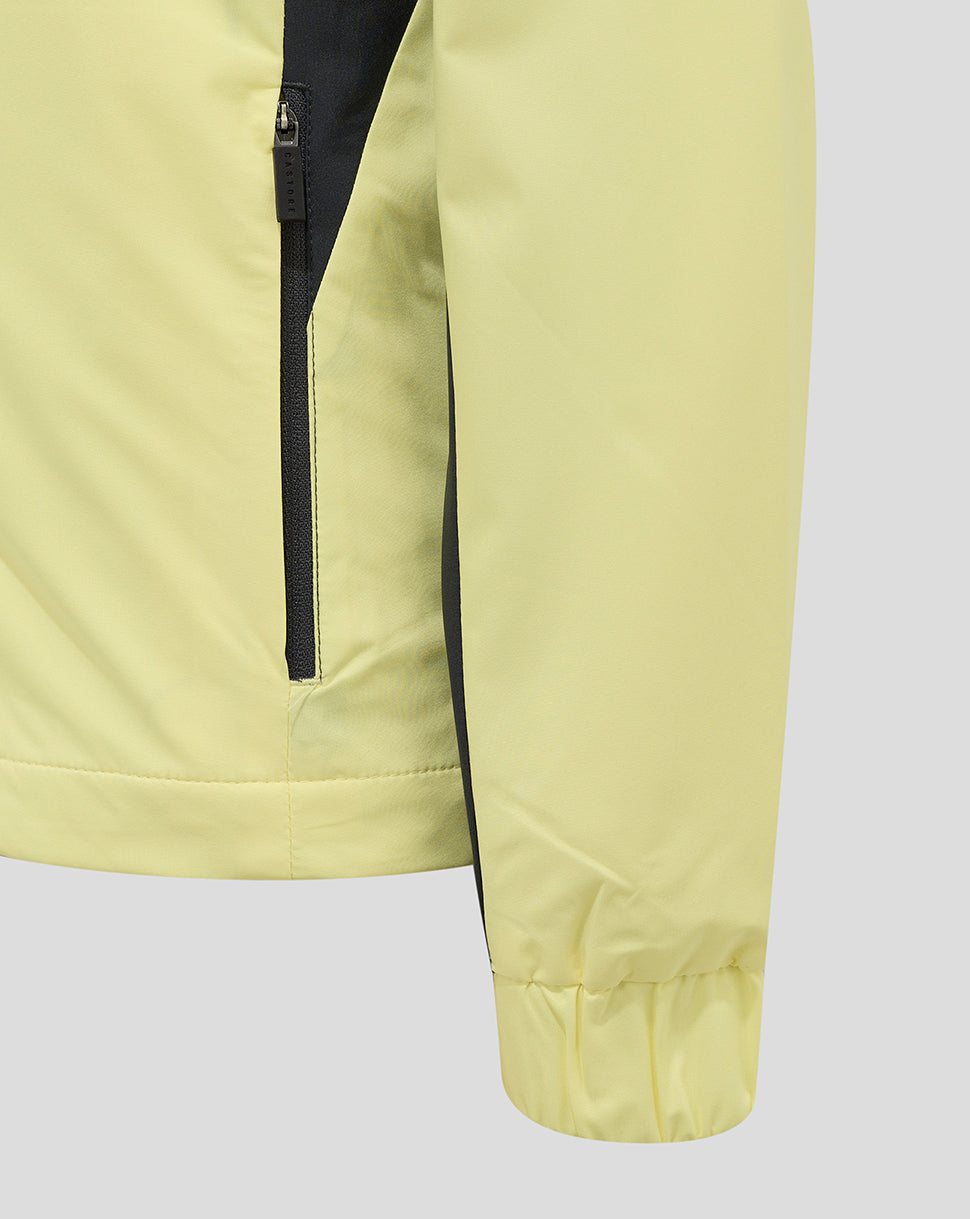 Close-up of pale yellow Everton 24/25 junior training rain jacket showing a vertical black zipper.