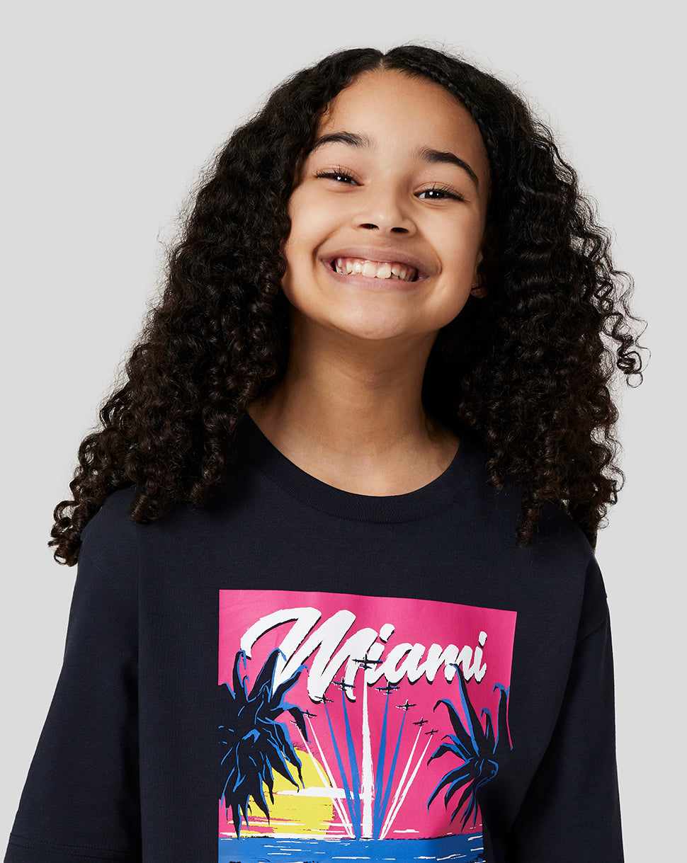 Smiling girl in a navy Miami graphic T shirt from Oracle Red Bull Racing