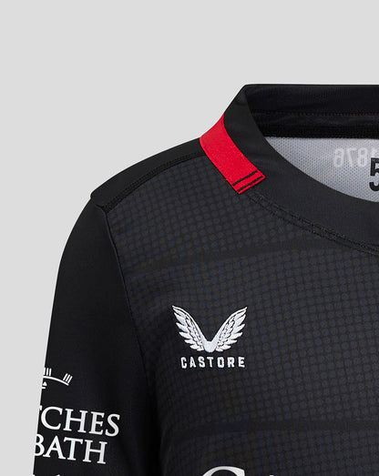 Close-up of shoulder and collar area of the Saracens home shirt with a red collar tab and Castore branding on the chest.