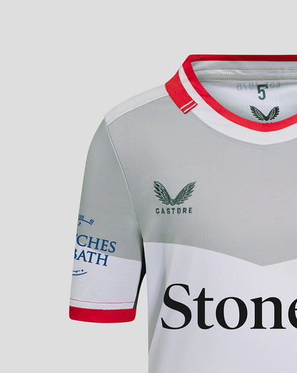 Close-up of chest area with Saracens crest and large StoneX sponsor on the away shirt
