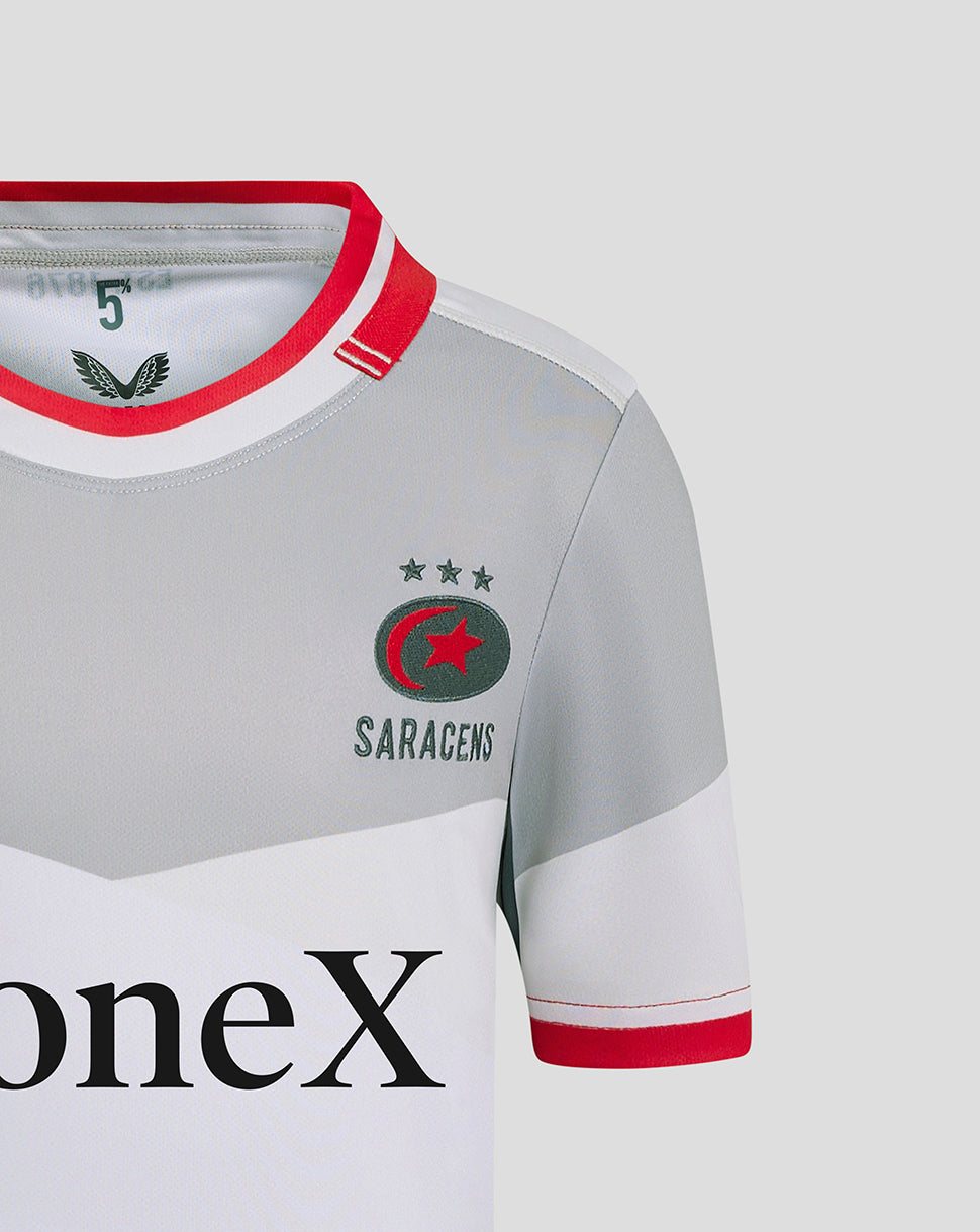 Close-up of left chest showing Castore logo and Saracens crest on grey away shirt with red collar trim