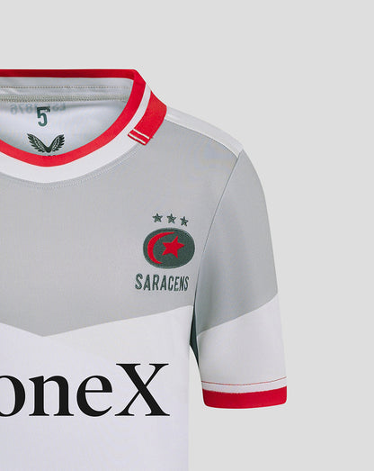 Close-up of left chest showing Castore logo and Saracens crest on grey away shirt with red collar trim
