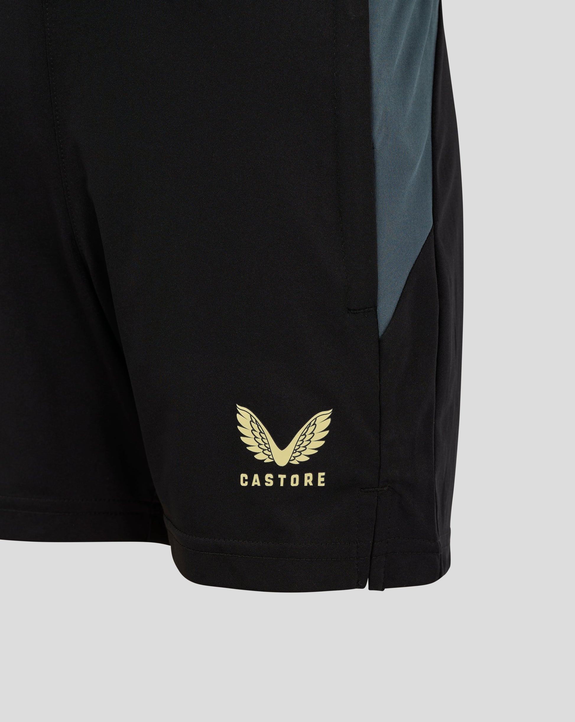 Side view of black Preston training shorts with teal panel and Castore branding at the hem