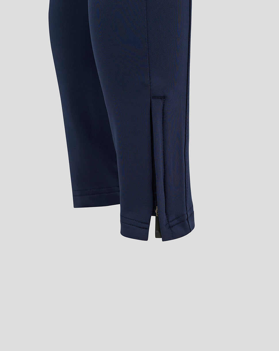 Close-up of navy training pants lower leg showing ankle zips and hem vent