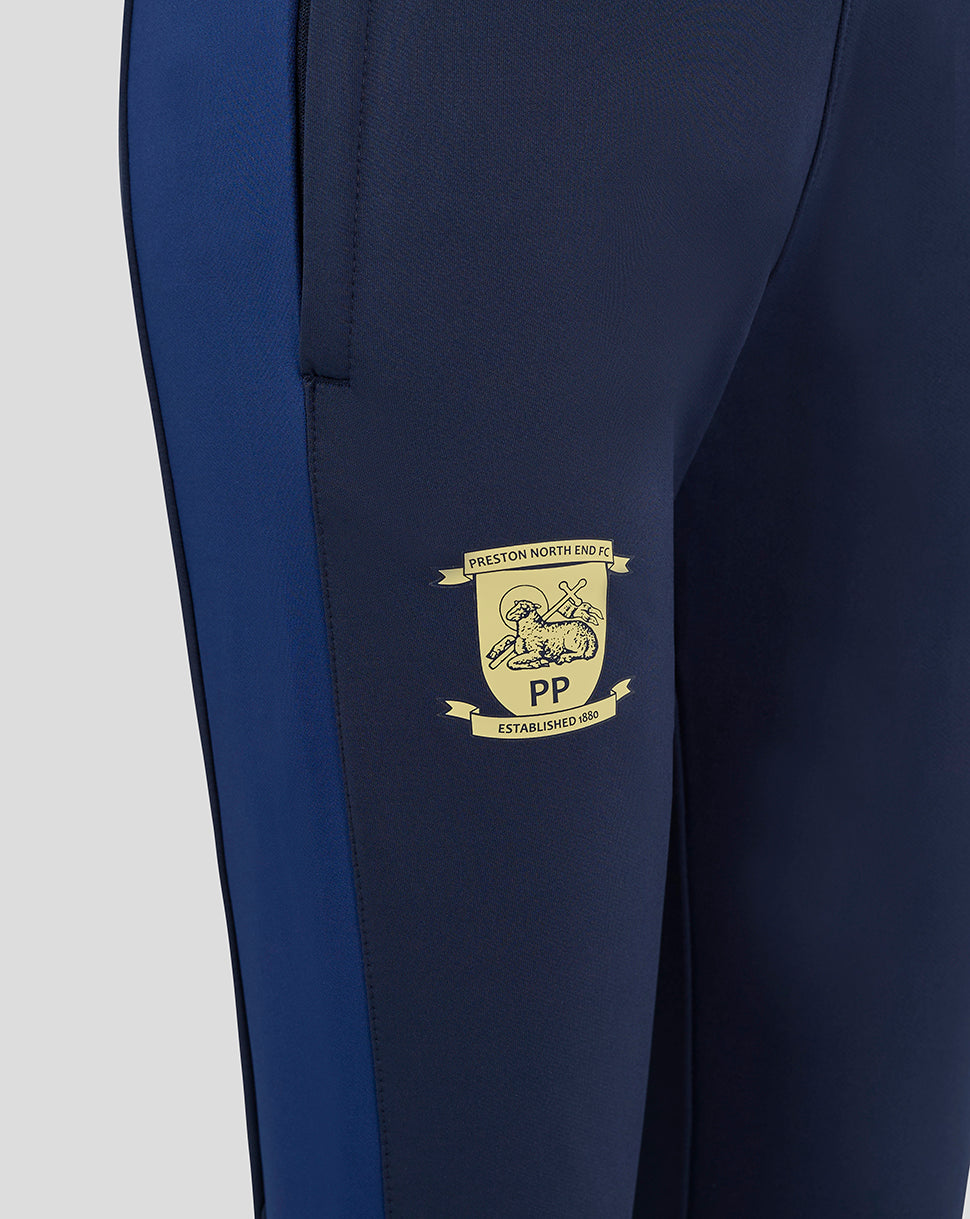 Close-up of navy Preston Junior Training Pants thigh area with club crest