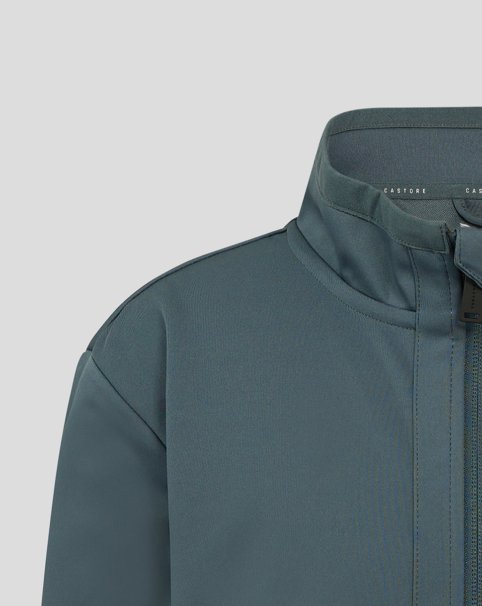 Close-up of Preston Junior 24/25 Travel Jacket collar with funnel neck and zip guard in teal softshell.