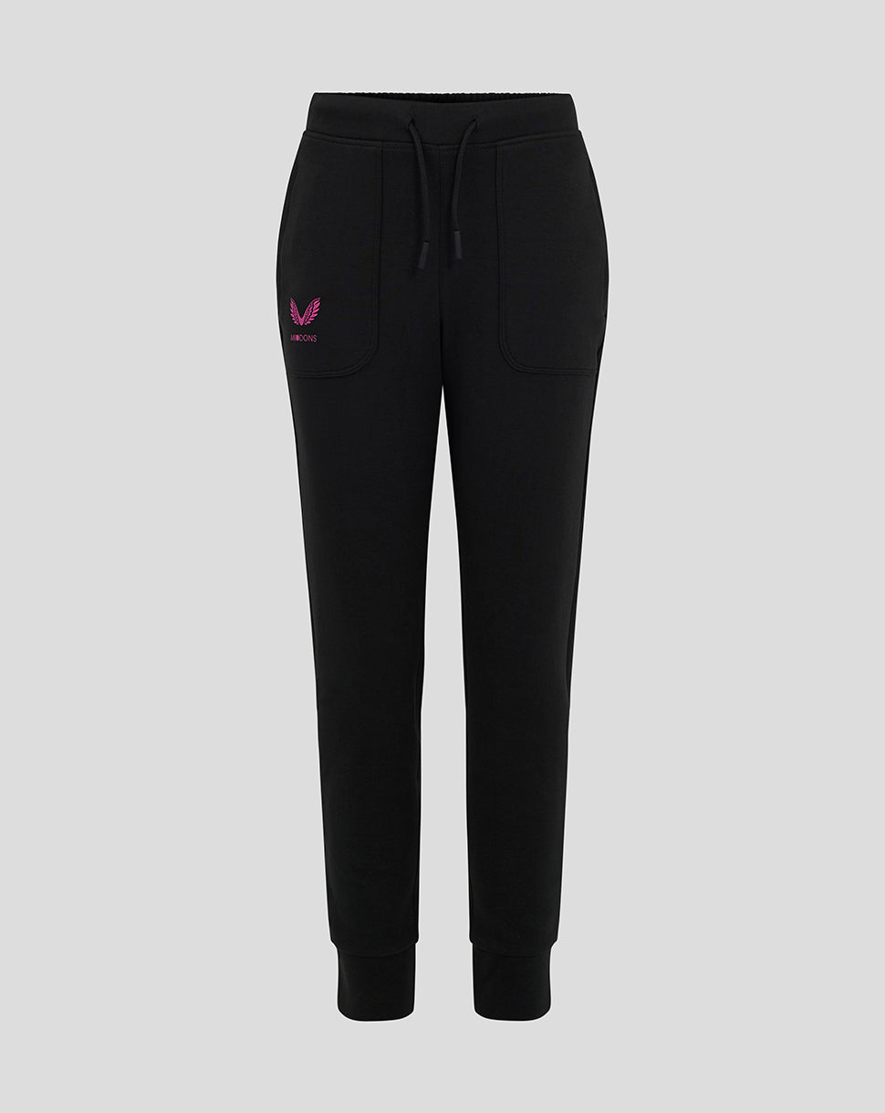 Front view of black Mk Dons junior travel pants with pink winged logo on the left thigh