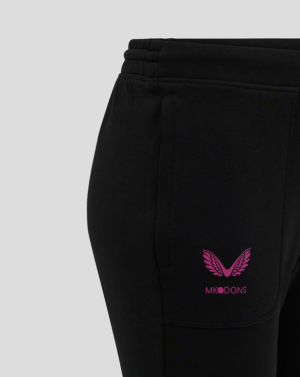 Close-up of black joggers showing the pink MK DONS logo near the left pocket