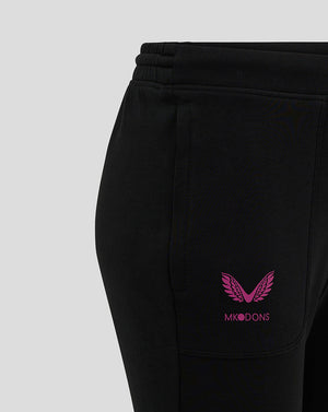 Close-up of black joggers showing the pink MK DONS logo near the left pocket