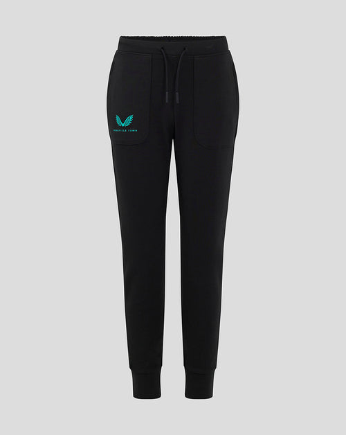 Front view of black Mansfield junior travel pants with teal logo on left thigh.
