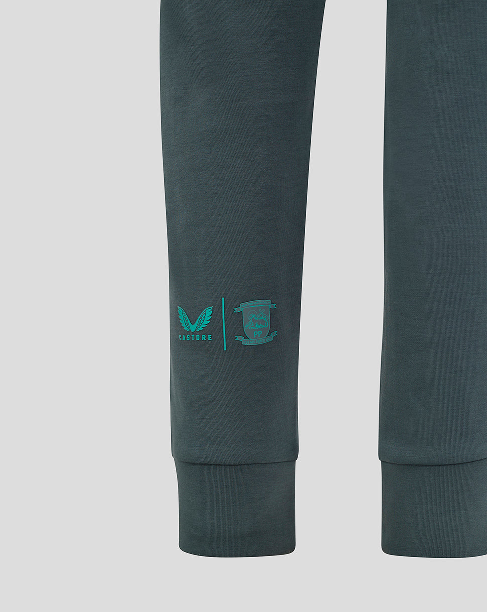 Left calf of dark teal Preston Junior 24/25 Travel Pant with PNE crest and Castore logo.