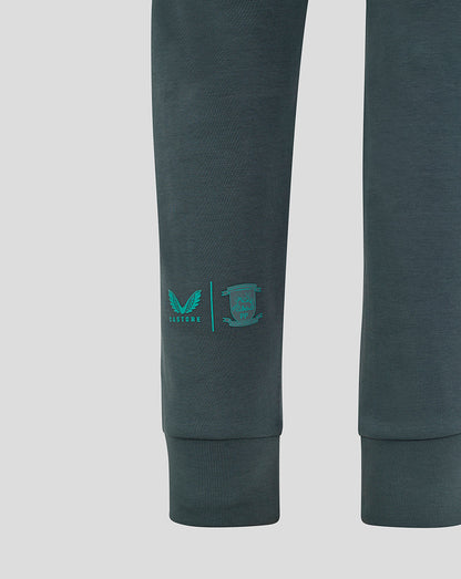 Left calf of dark teal Preston Junior 24/25 Travel Pant with PNE crest and Castore logo.