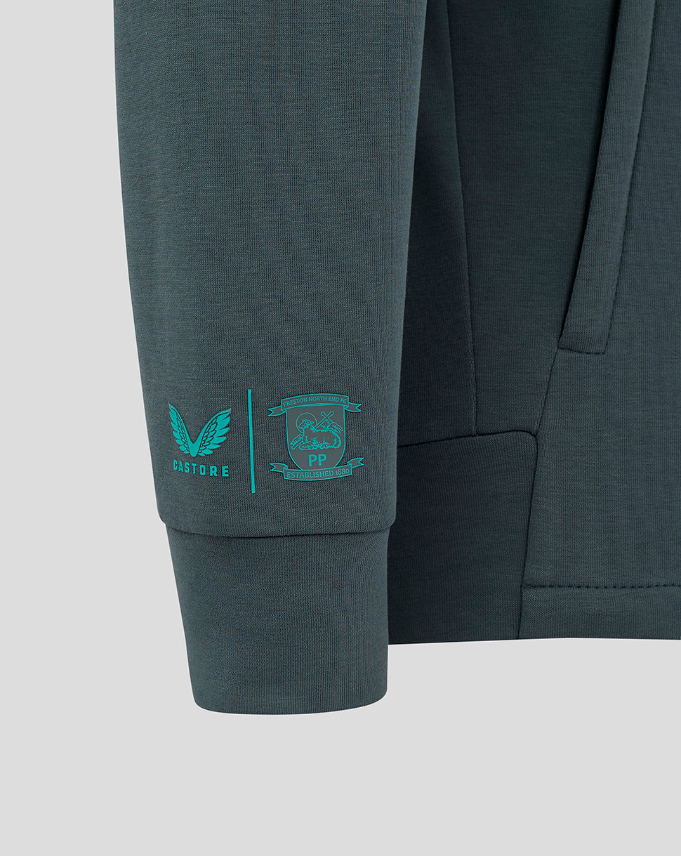 Teal Castore emblem and PNE crest printed on the dark teal sleeve of the junior travel jacket