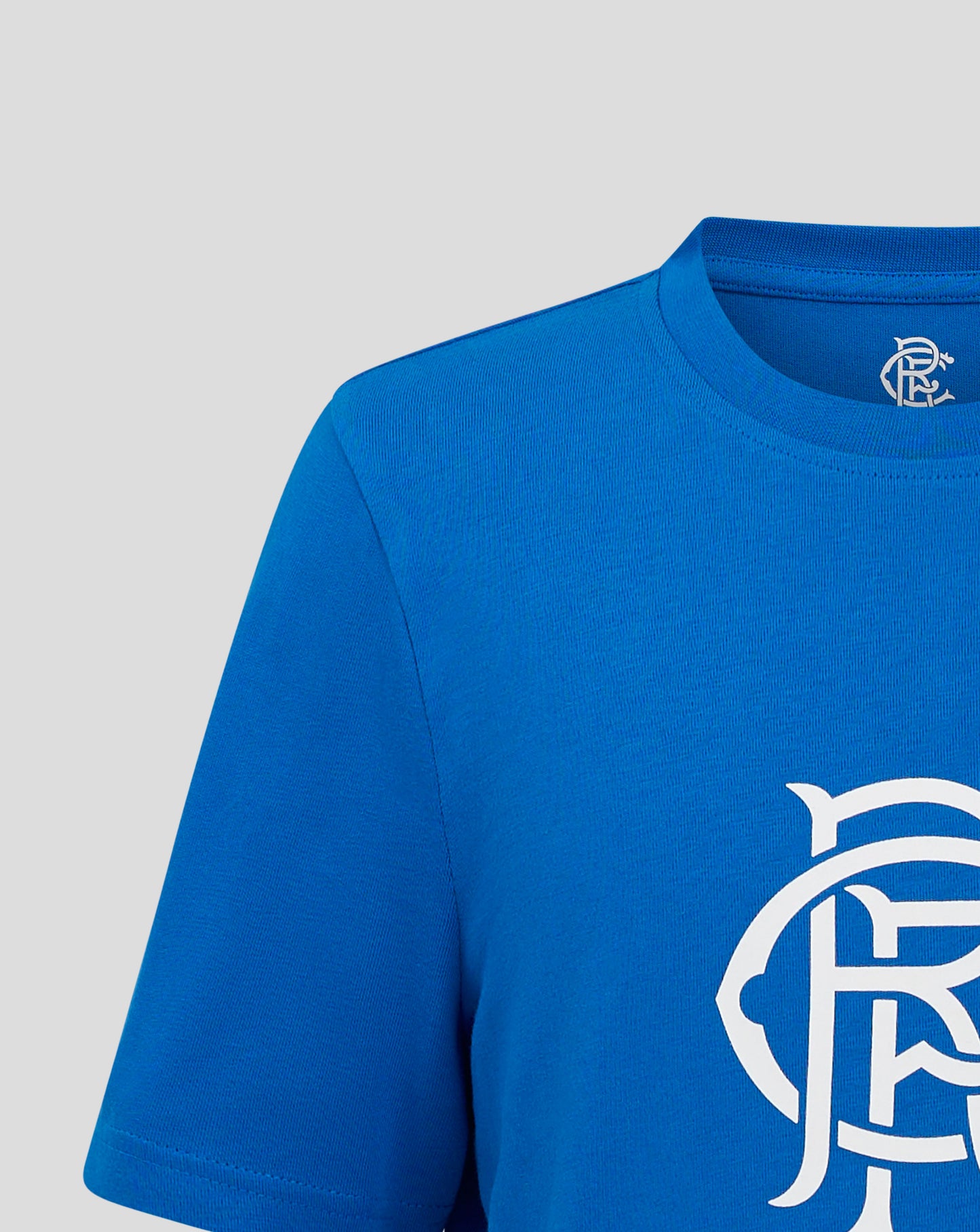 Close-up of a blue Rangers Junior Crest T-Shirt neck area with a small logo on the inside and part of the crest visible on the chest.