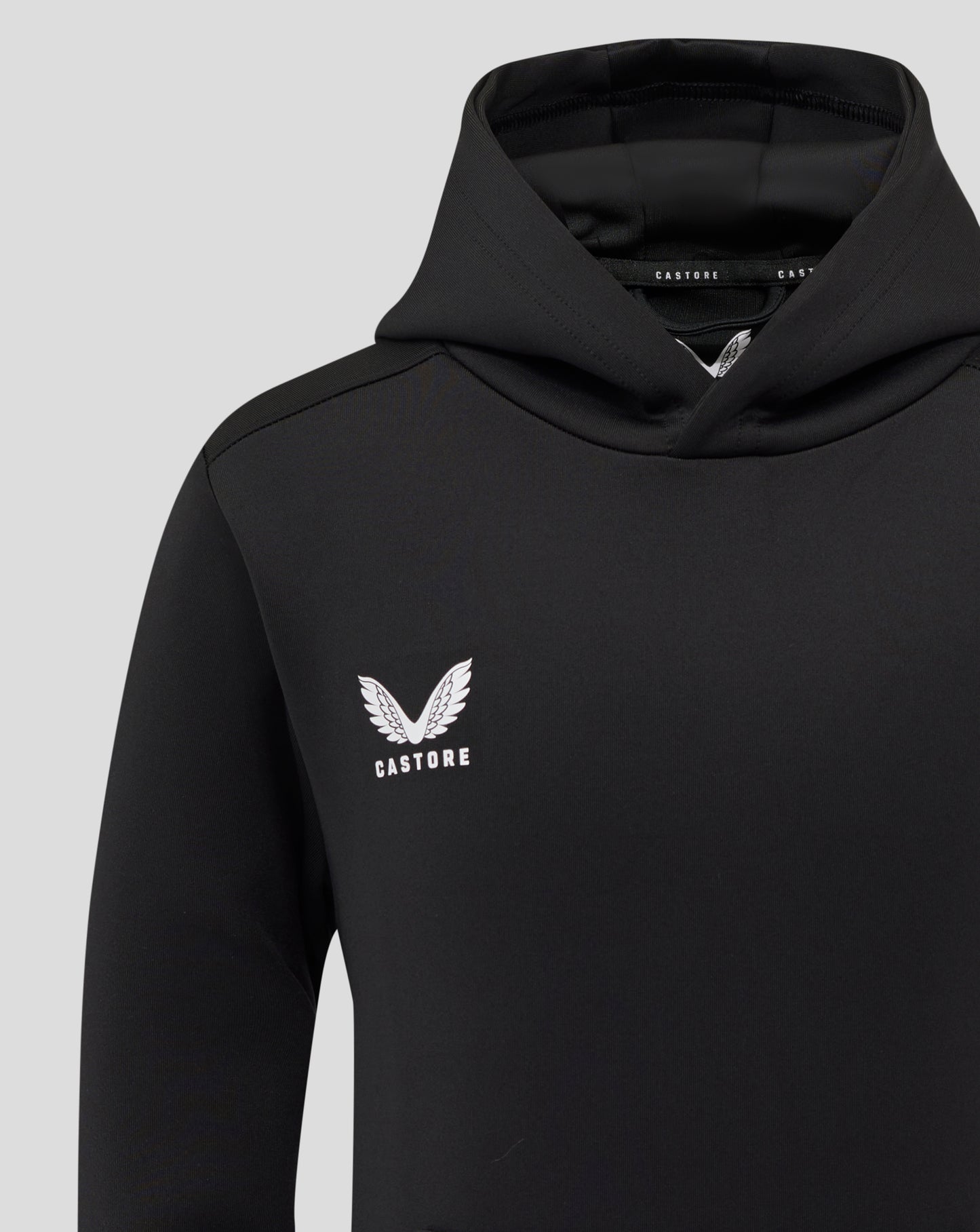 Black hoodie chest with white Castore logo and wing emblem.