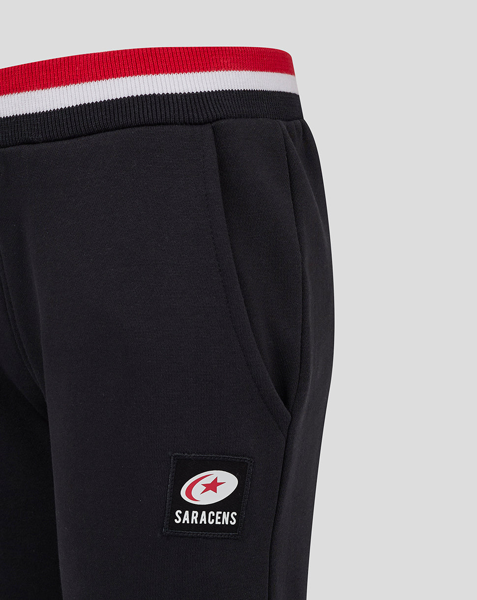 Black Saracens Junior joggers with red white black striped waistband and a Saracens patch at the hip
