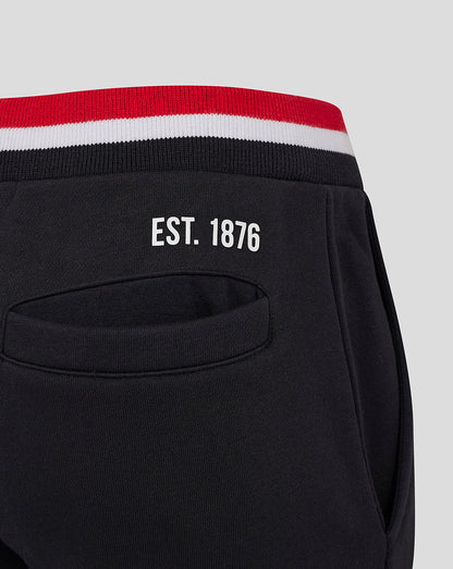 Back view of black Saracens Junior Classic Joggers with EST 1876, back pocket and red white striped cuffs.