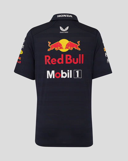 Back view of navy junior polo shirt with large Red Bull emblem across the upper back and sponsor logos