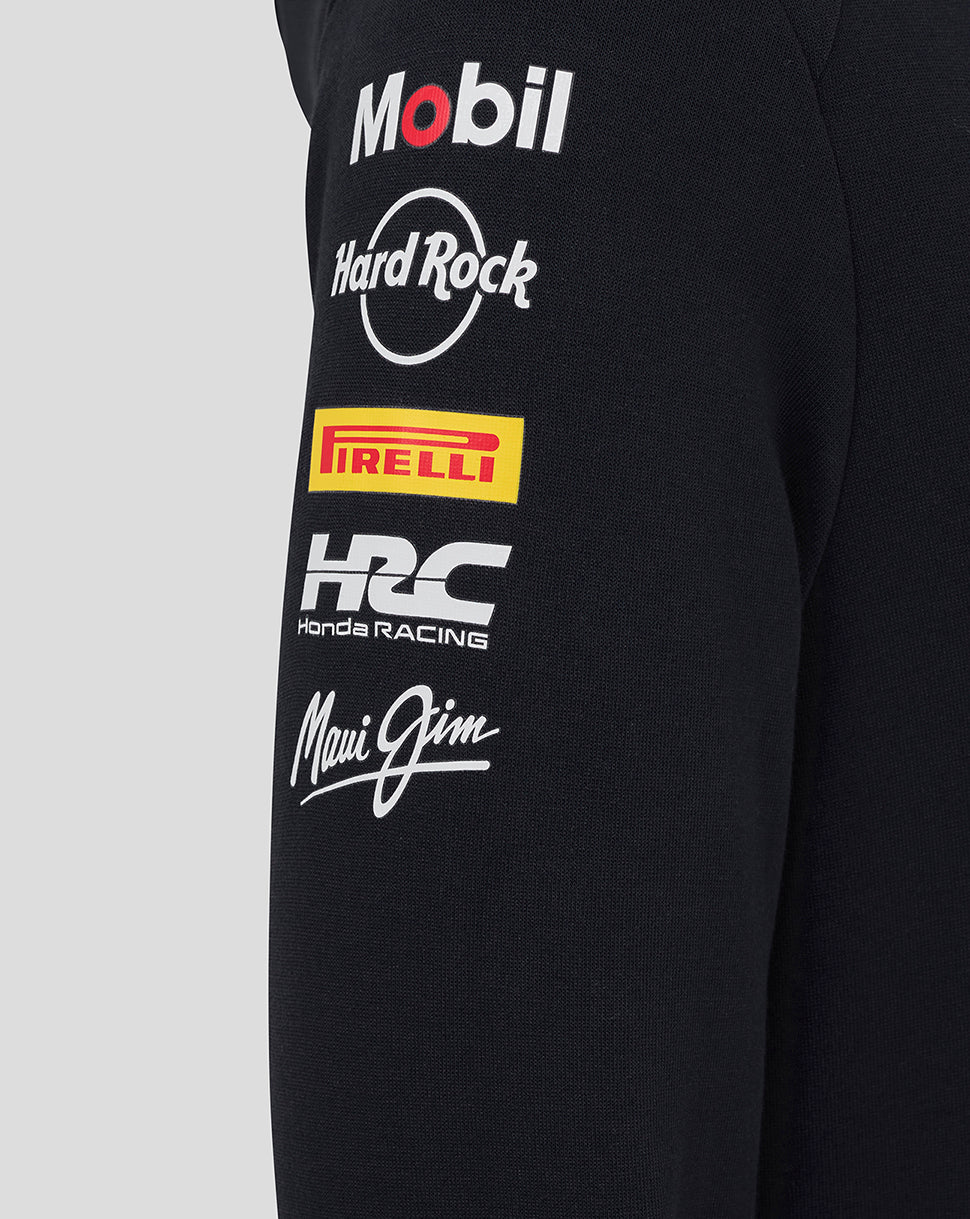 Left sleeve of black Junior Teamline hoodie adorned with sponsor logos including Mobil Hard Rock Pirelli Honda Racing and Maui Jim.