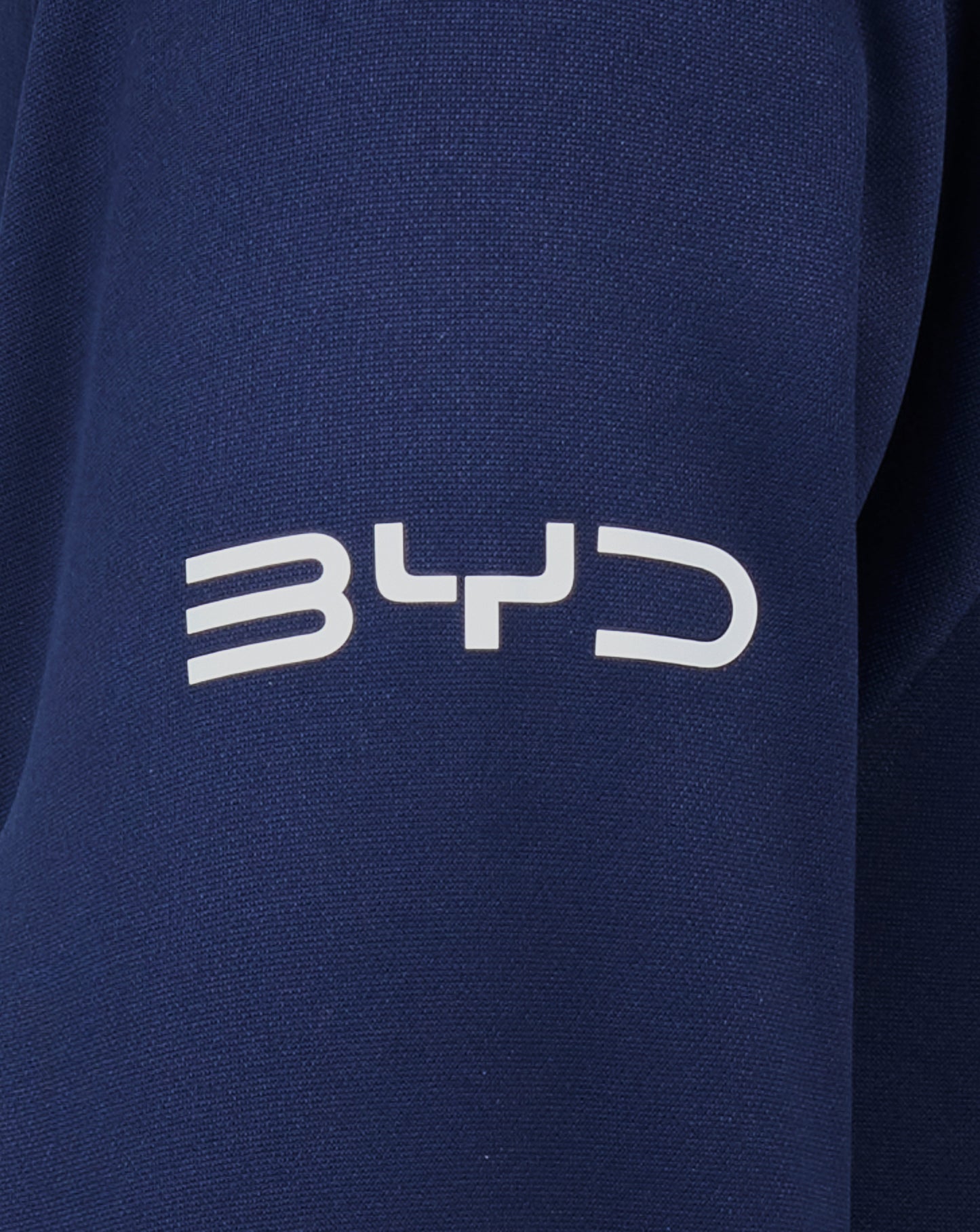 Close up of navy fabric from the Sydney Roosters 2025 Junior Pro Players Hoodie with white lettering visible at the bottom.