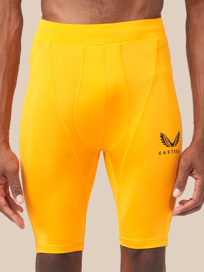 Front view of bright yellow Active Base Layer Shorts with panel seams and Castore logo on the thigh