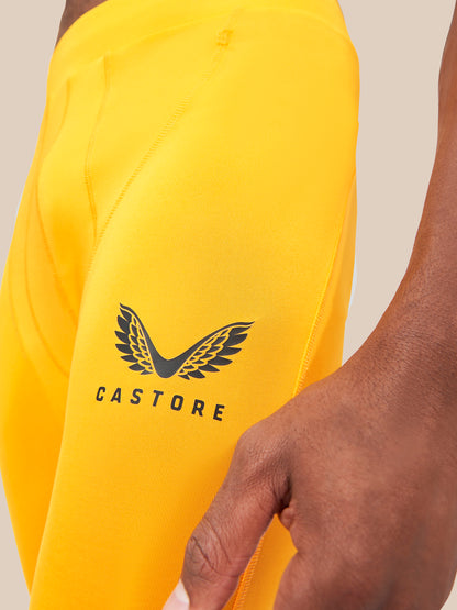 Close up of the bright yellow shorts showing the Castore wing logo on the thigh