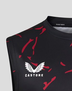 Close up of black sleeveless training singlet with red splatter pattern and Castore logo near the neckline.
