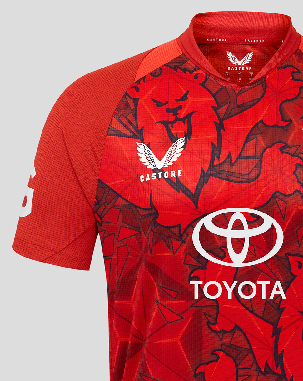Close-up of front of red England T20 Pro Shirt 25/26 featuring large Toyota logo and graphic pattern.