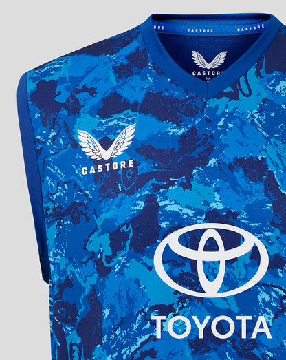 Close-up of chest area showing Castore branding and England crest on the blue camo vest.