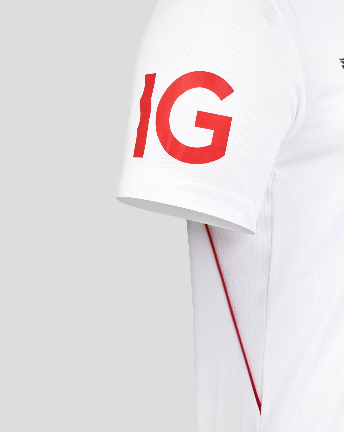 Sleeve detail of white England Ashes replica shirt showing large red letters IG and red piping.