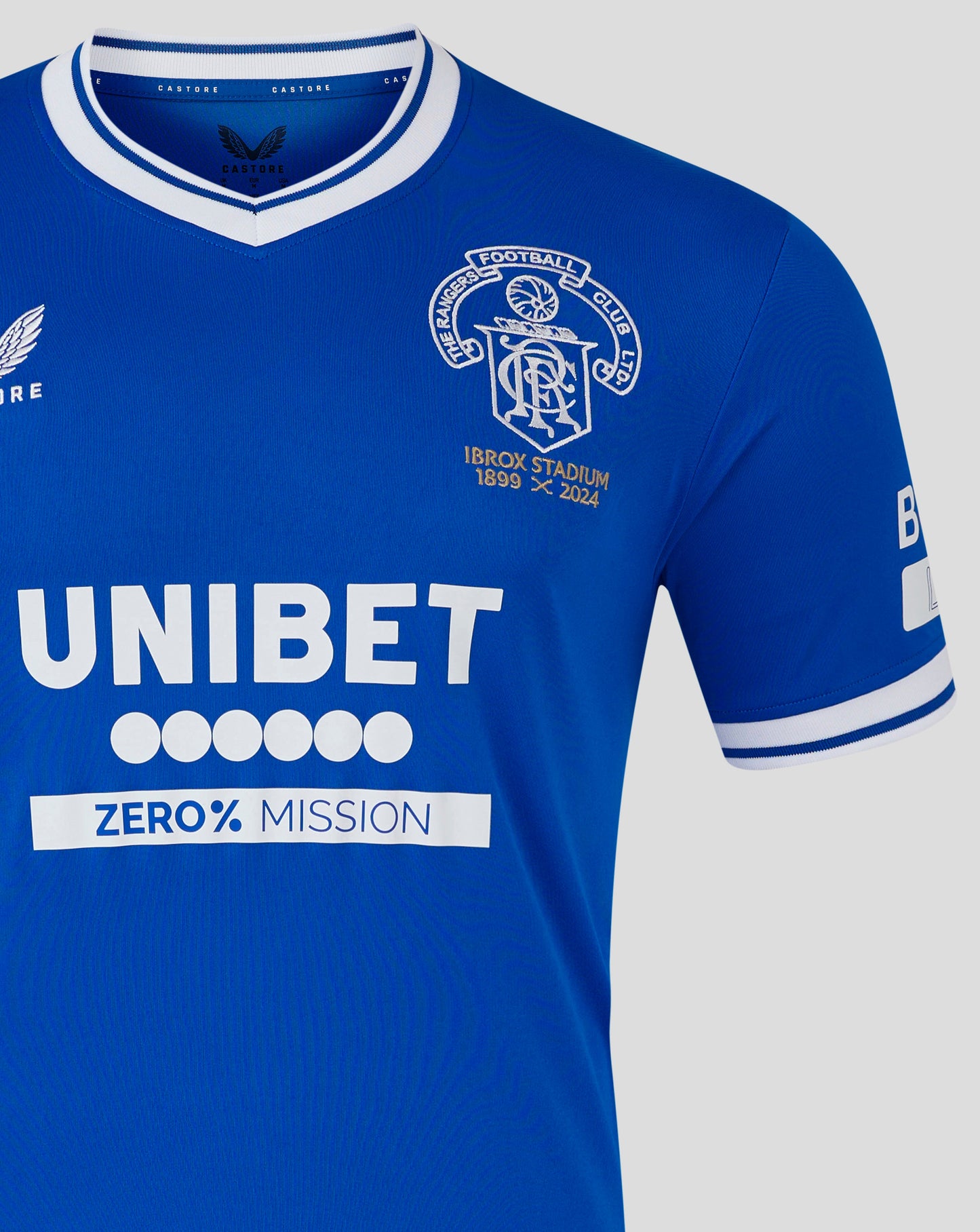 Close up of blue Ibrox 125 Heritage shirt collar with white trim and crest on the chest