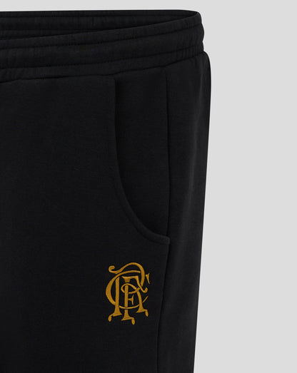 Close up of the back hip area on black Rangers FC joggers showing gold crest embroidery beside the pocket