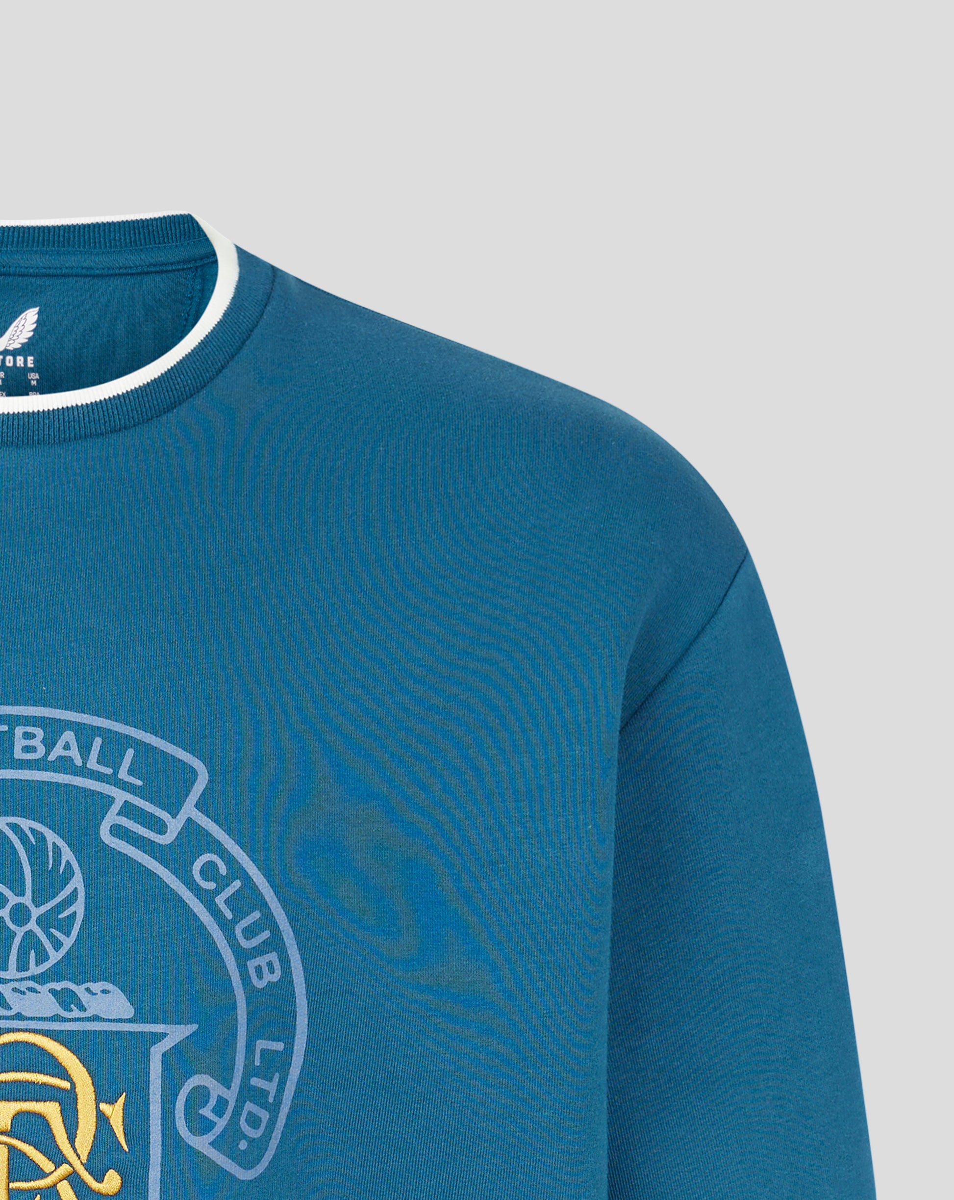 Close-up of blue Rangers FC heritage crewneck showing ribbed collar with white trim.