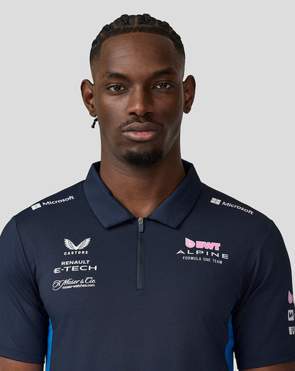 Head and shoulders of a man in a navy BWT Alpine Formula One Team polo with chest logos visible