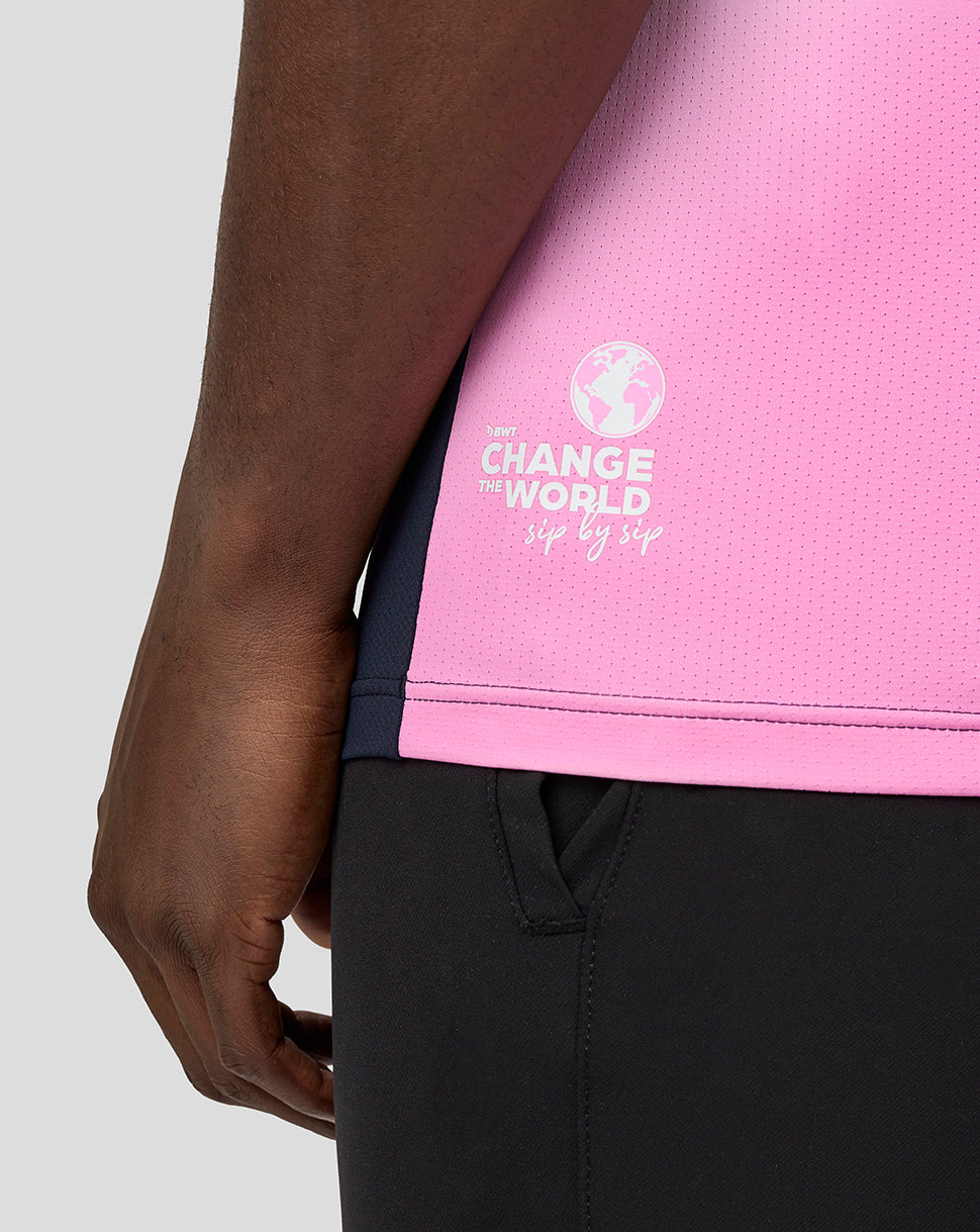 Close-up of pink dotted fabric with a white globe logo and Change the World slogan on the side of a BWT Alpine shirt
