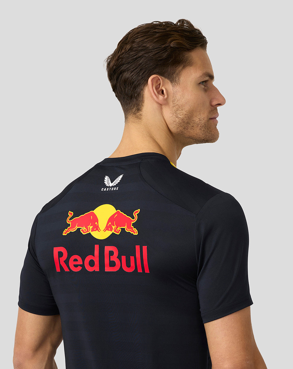Back view of a man wearing a navy Red Bull Racing t shirt with a large Red Bull logo across the back
