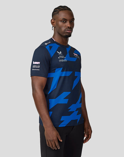 Side-profile close-up of a man in navy BWT Alpine driver jersey featuring blue geometric patterns.