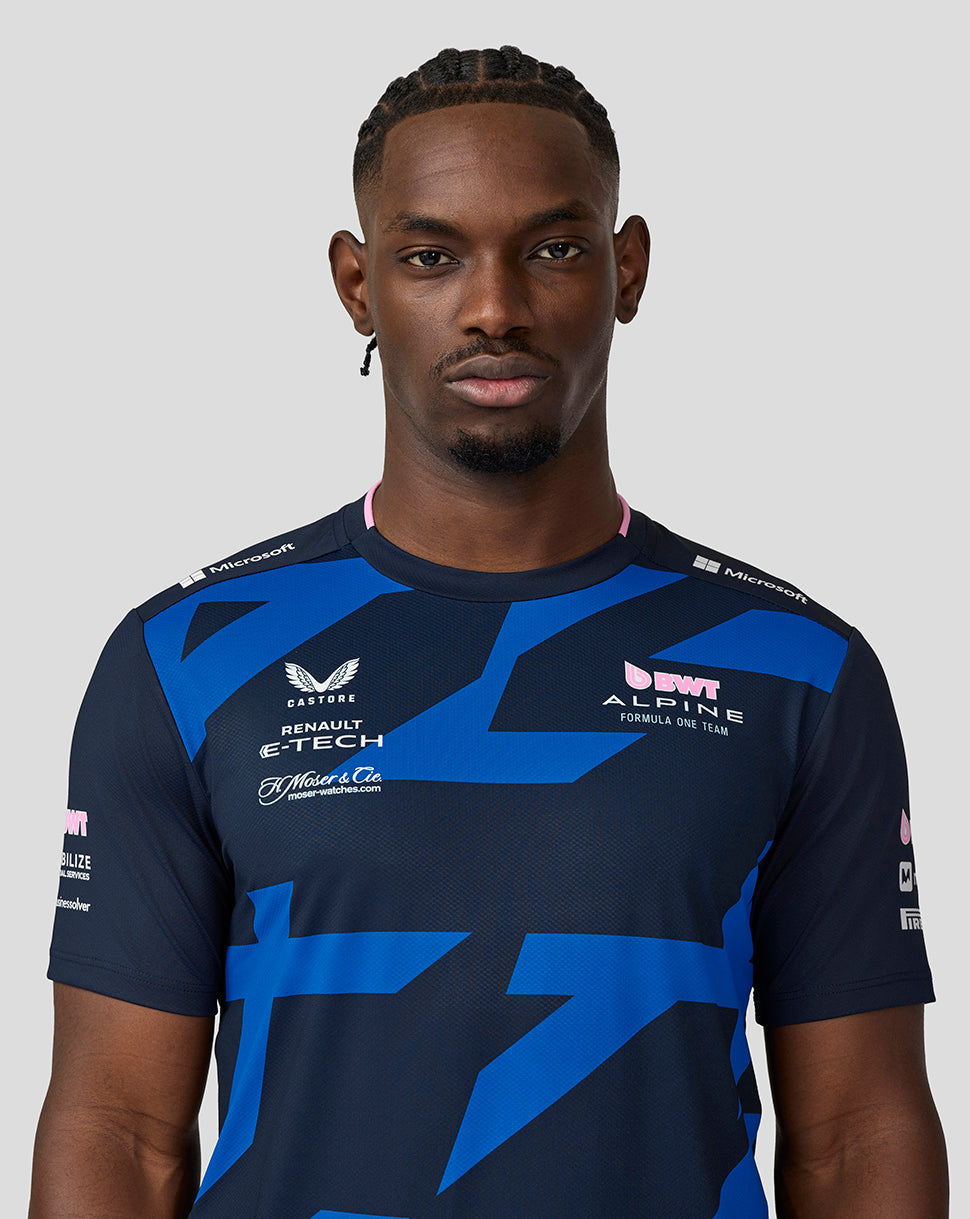 Close-up of chest on navy BWT Alpine driver jersey showing bold blue graphic and sponsor logos.